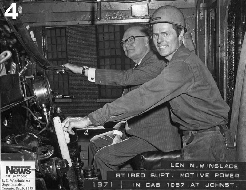 John Clarke and another man pose inside the cab of a locomotive.