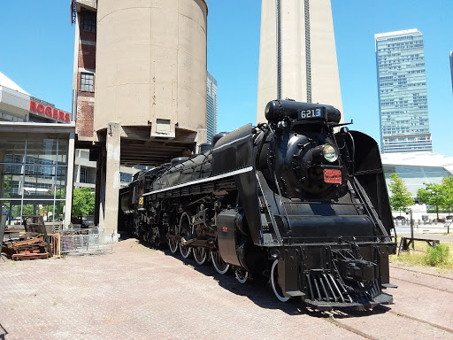 The freshly painted locomotive sits in the sun on a bright, summer day at the Toronto Railway Museum.