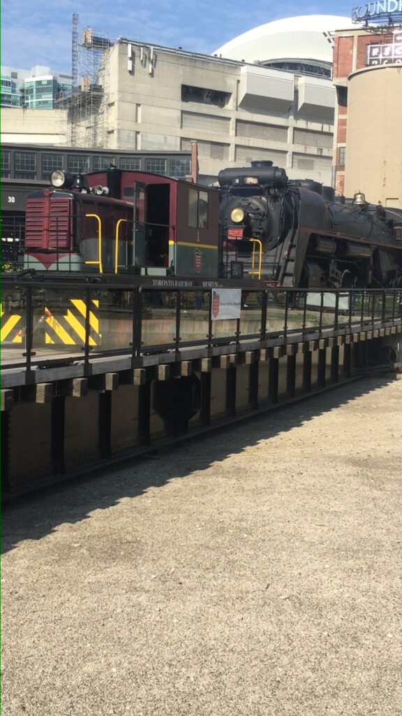 No. 1 hauls CN No. 6213, a black steam locomotive, onto the museum turntable.