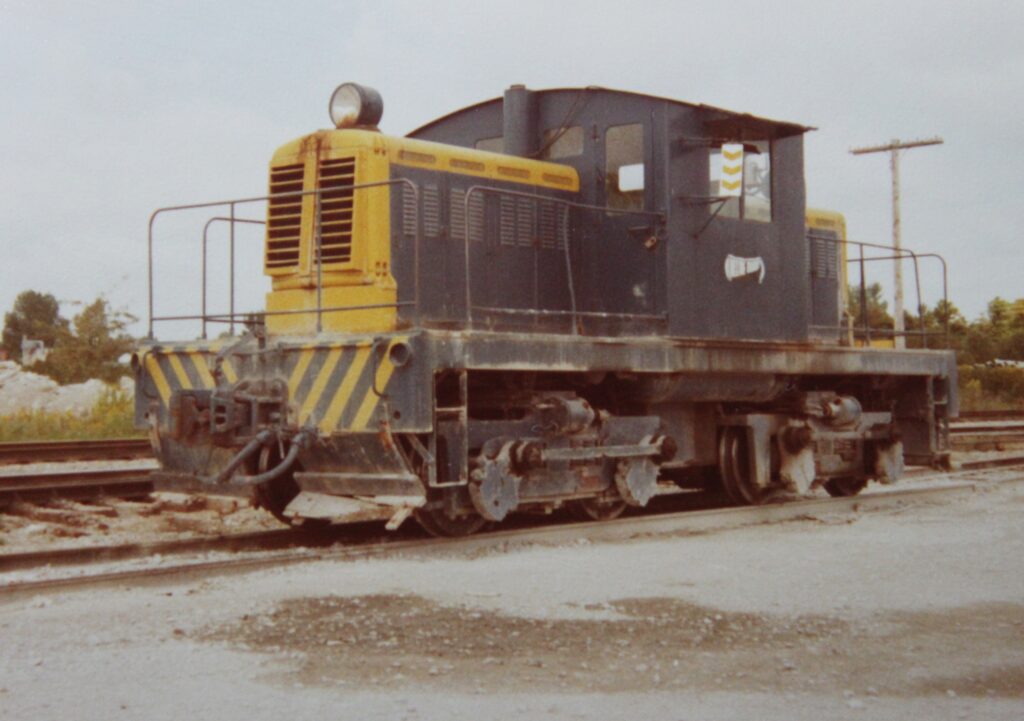 The No. 1 locomotive is painted yellow and navy blue, and is posed on a set of railway tracks.
