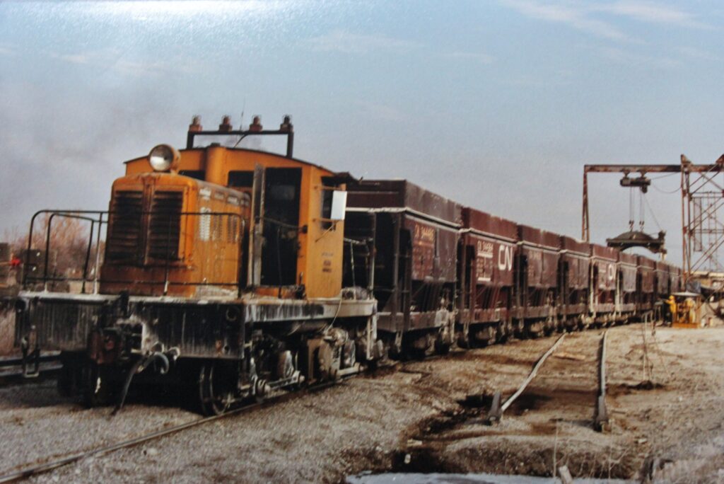 Historical photo of No. 1 hauling a long train of Canadian National Railways hopper cars.
