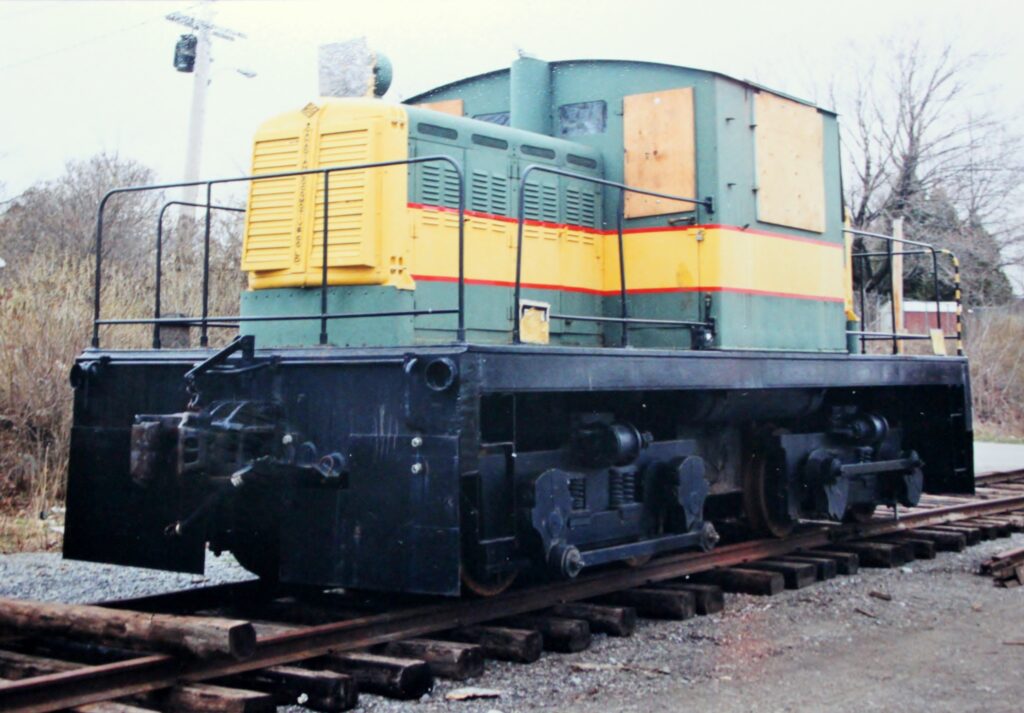 The windows of No. 1 are boarded up and the paint is peeling in this photo. The locomotive rests on a set of railway tracks.