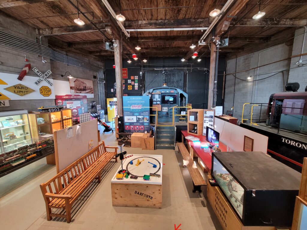 Interior of the museum space showing a railway bench for seating and kids toy train table