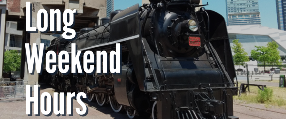 A black steam locomotive parked outdoors. Text reads Long Weekend Hours