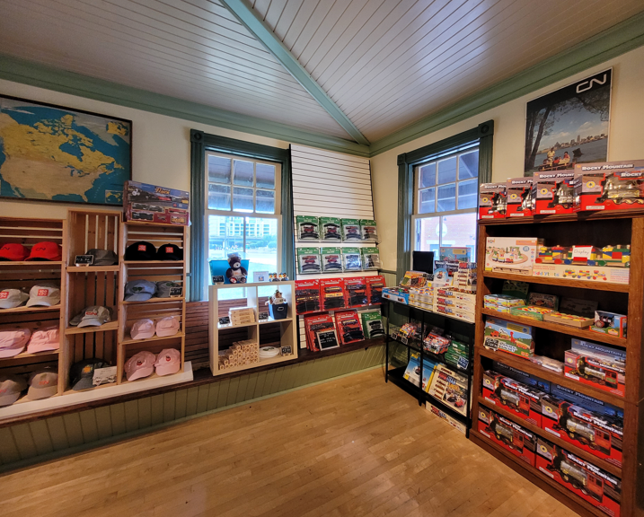 Museum gift shop shelves filled with hats, puzzles, toy trains