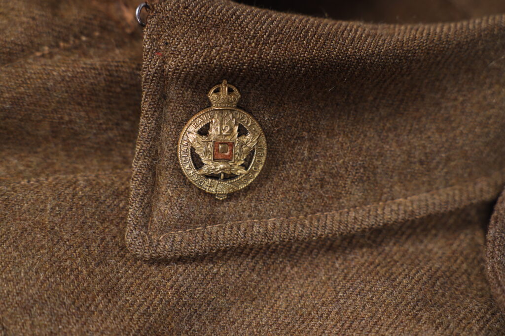 Close up of a metal pin on a uniform jacket