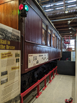 Nova Scotia railing along the pit under its wheels with exhibit space alongside the car